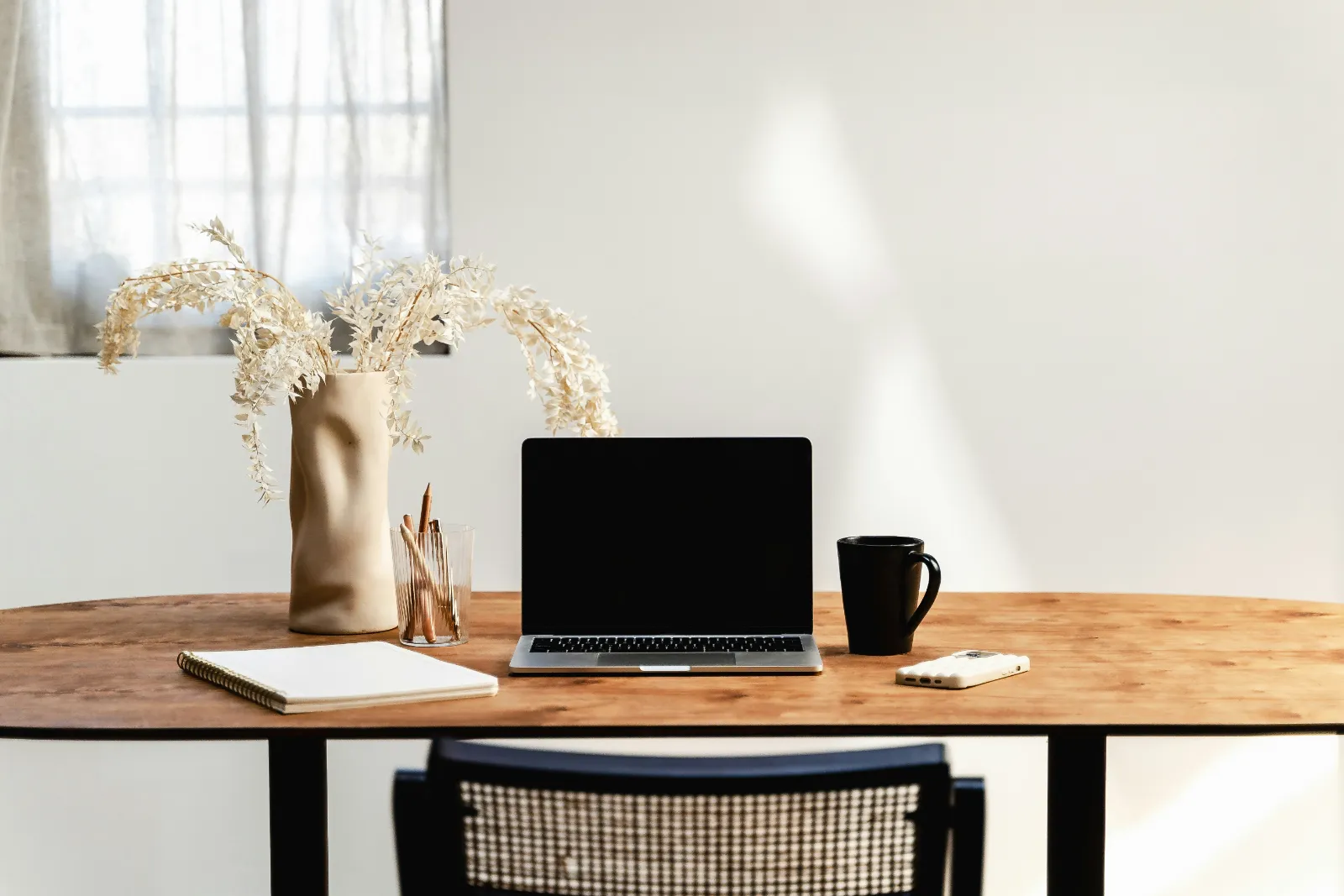 Organized desk with a laptop for clean-up and catch-up bookkeeping