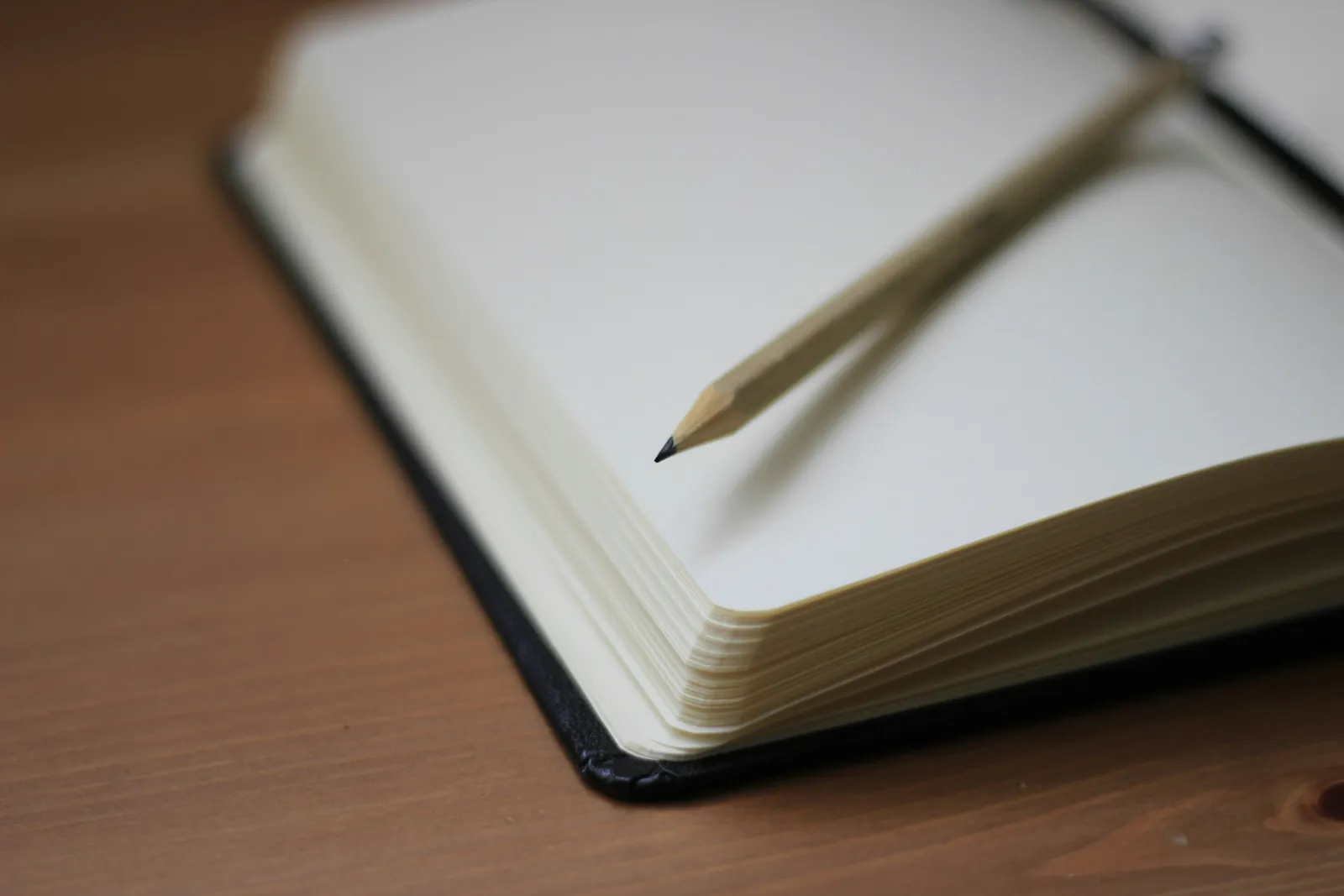 Open notebook and pen for tracking jobs and projects